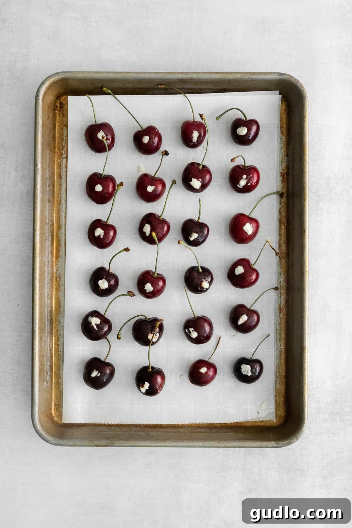 Velvet Cherry Mascarpone Chocolates 3 An irresistible close-up of a chocolate covered cherry, revealing its creamy mascarpone filling, enticing viewers to indulge.