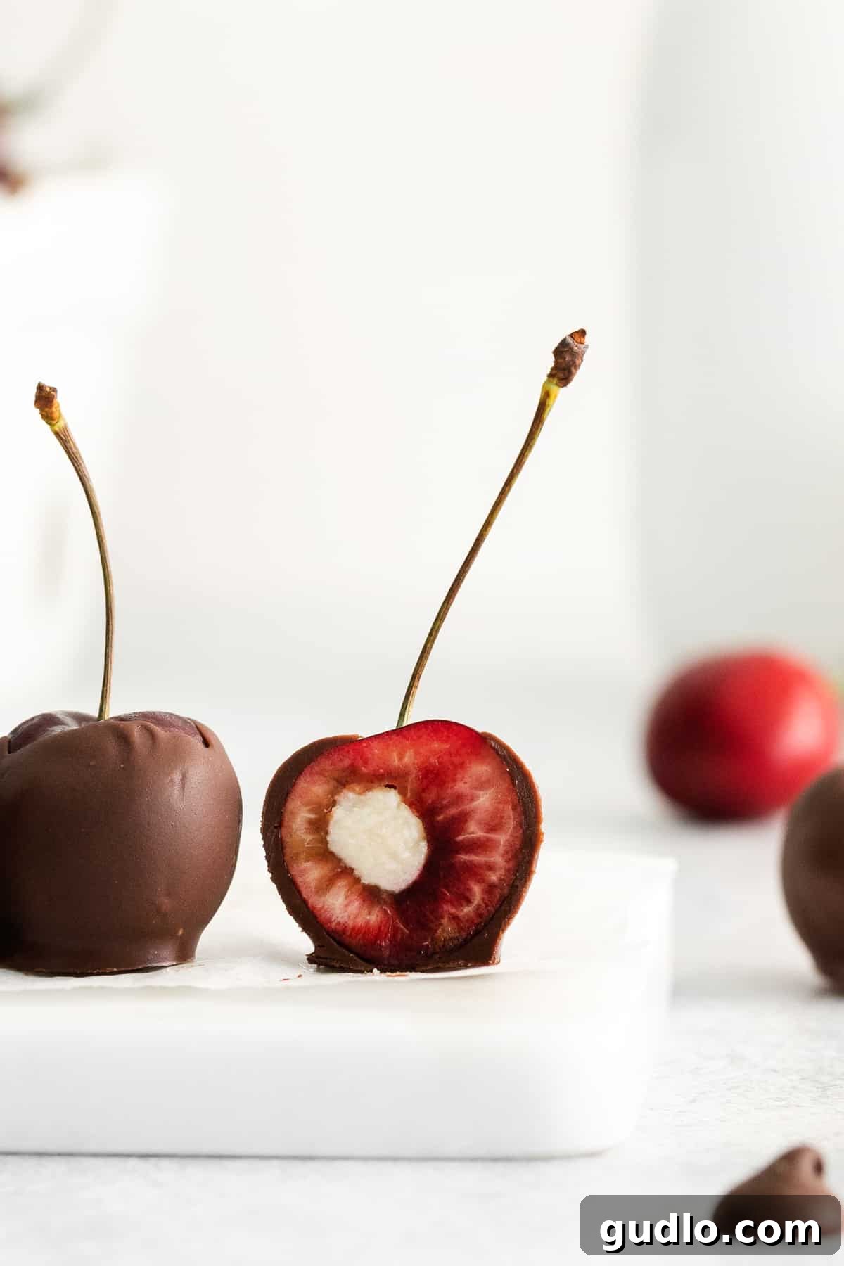 Velvet Cherry Mascarpone Chocolates 9 A close-up shot of several perfectly finished chocolate covered cherries, showcasing their glossy chocolate coating and elegant presentation.