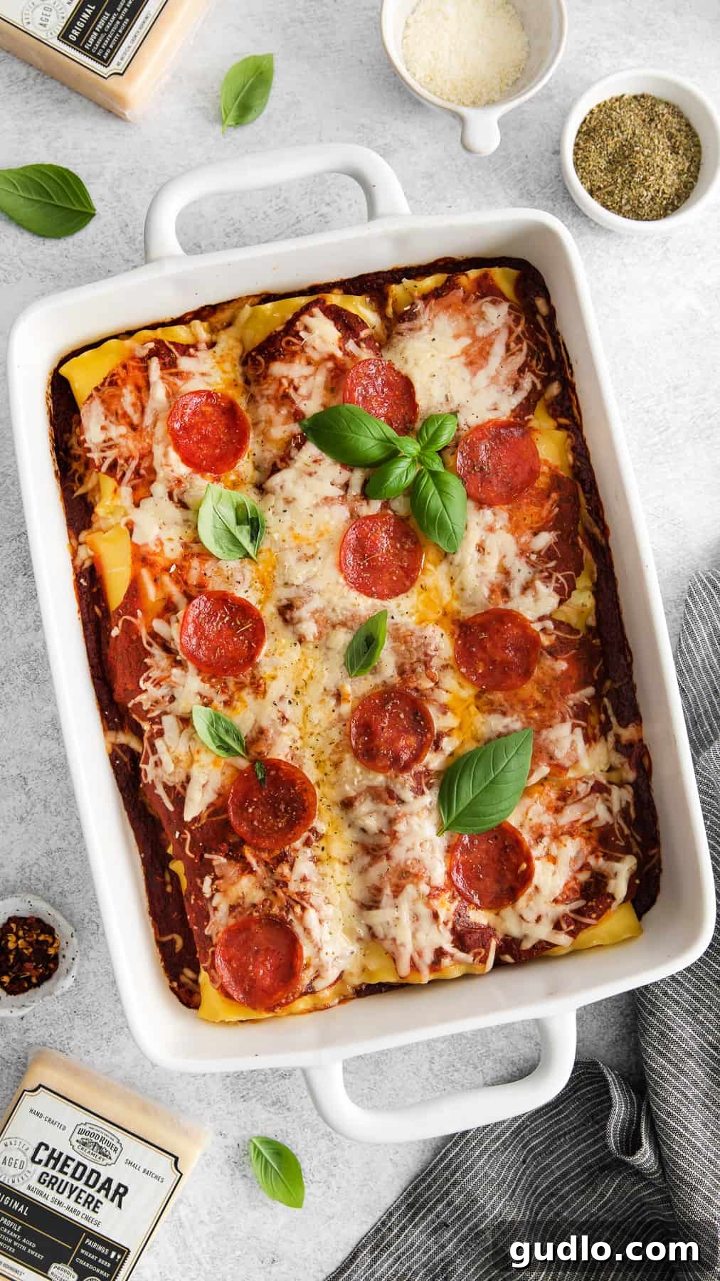 Delectable Pizza Lasagna Roll Ups for a Crowd-Pleasing Meal Golden-brown Pizza Lasagna Roll Ups topped with melted cheese and pepperoni, fresh out of the oven in a casserole dish.