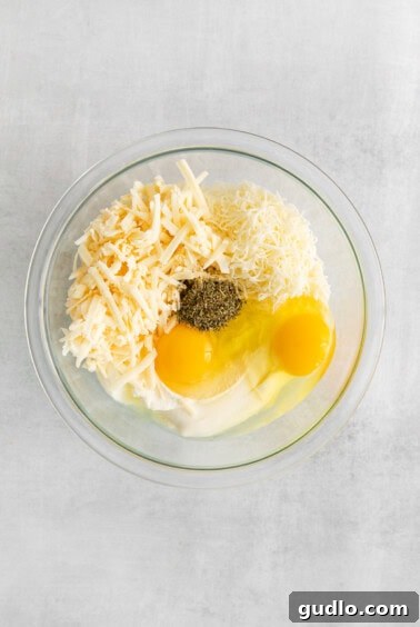 Pizzagna Swirls 5 Cheese mixture with eggs in a bowl.