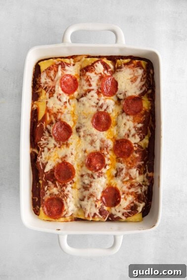 Pizzagna Swirls 10 Baked pizza lasagna roll ups in a casserole dish, ready to serve.