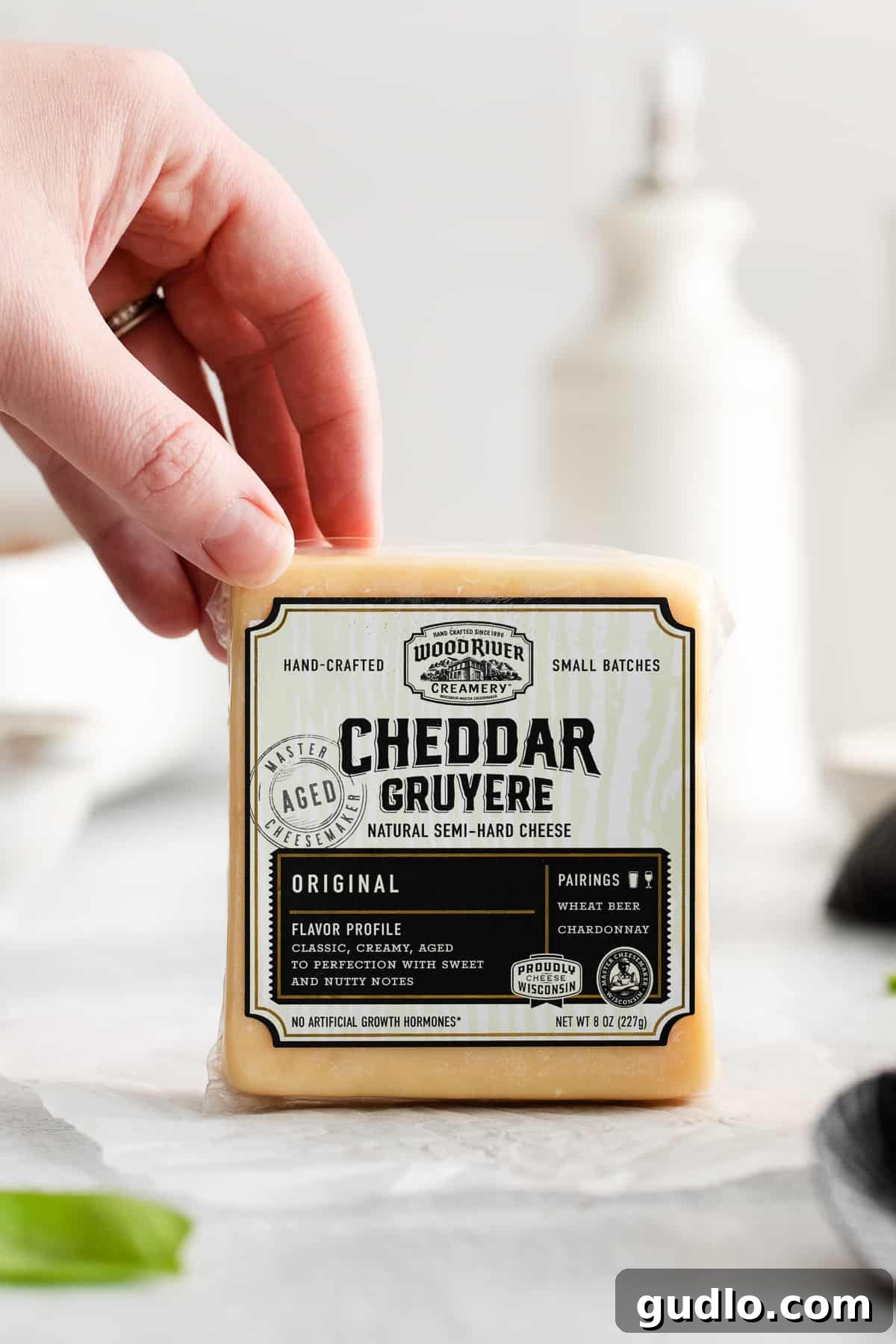 Premium Wood River Creamery Cheddar Gruyere Cheese A beautifully crafted block of Wood River Creamery's signature Cheddar Gruyere cheese, ready for grating.