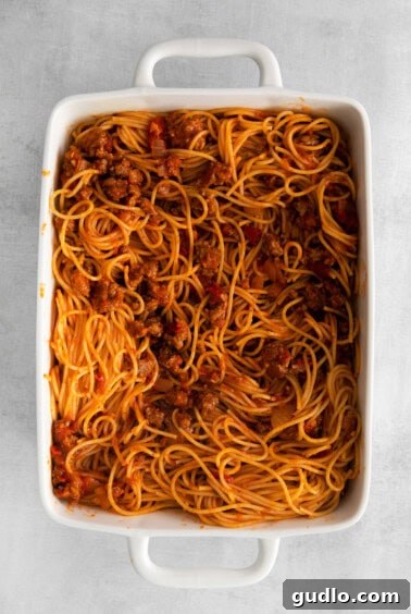 spaghetti and meat sauce transferred to a casserole dish.