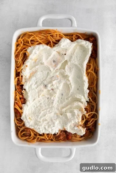 creamy ricotta spread over spaghetti, topped with marinara sauce.