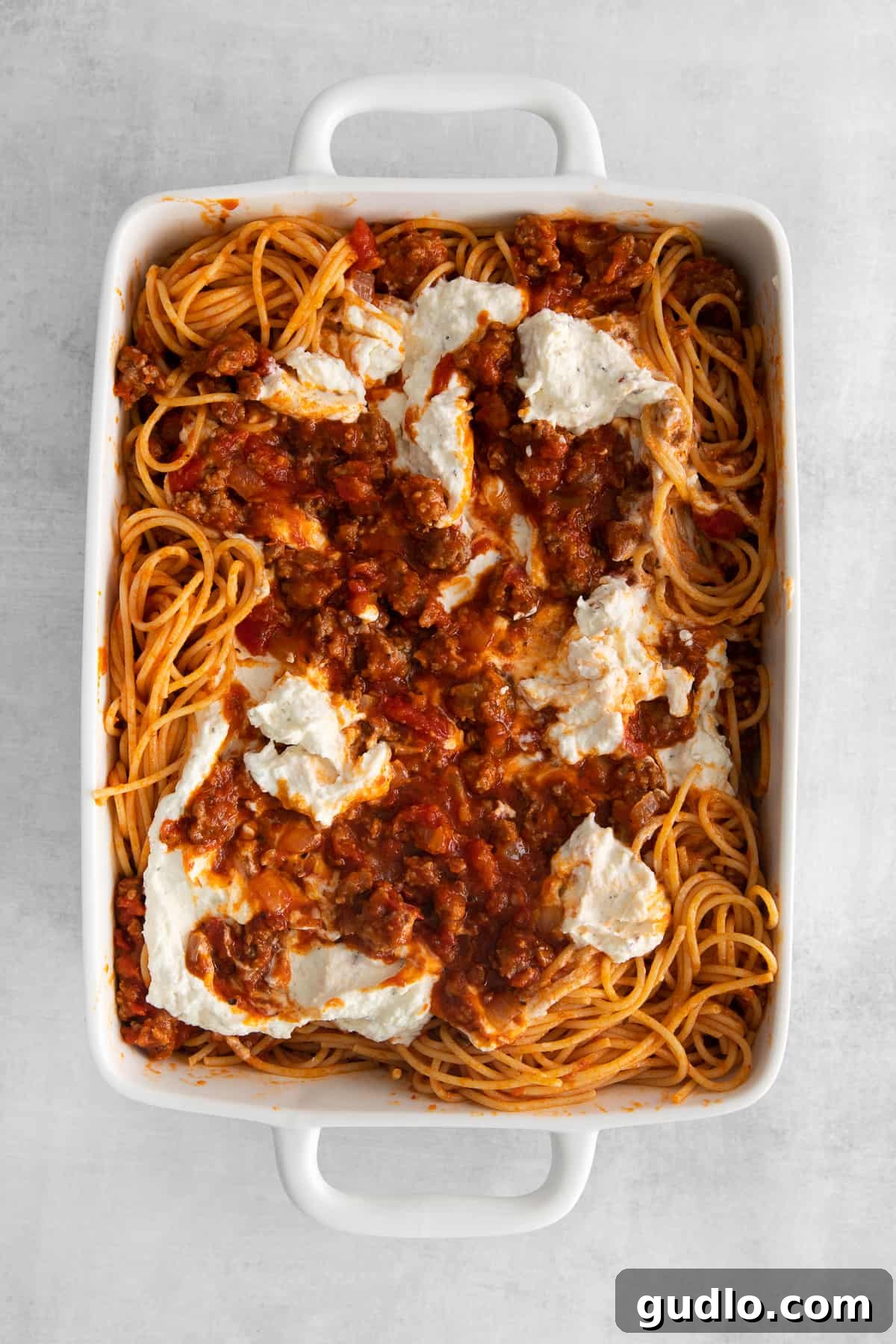 Baked spaghetti with cream cheese is an excellent kid-friendly, weeknight meal that makes for great leftovers! baked spaghetti in a casserole dish, fresh out of the oven, bubbling with cheese.