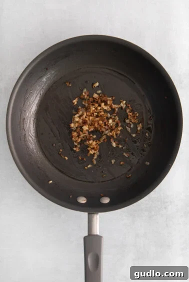 Burger Ball Bombs 4 Sautéed minced onions in a frying pan, caramelized to a golden brown.