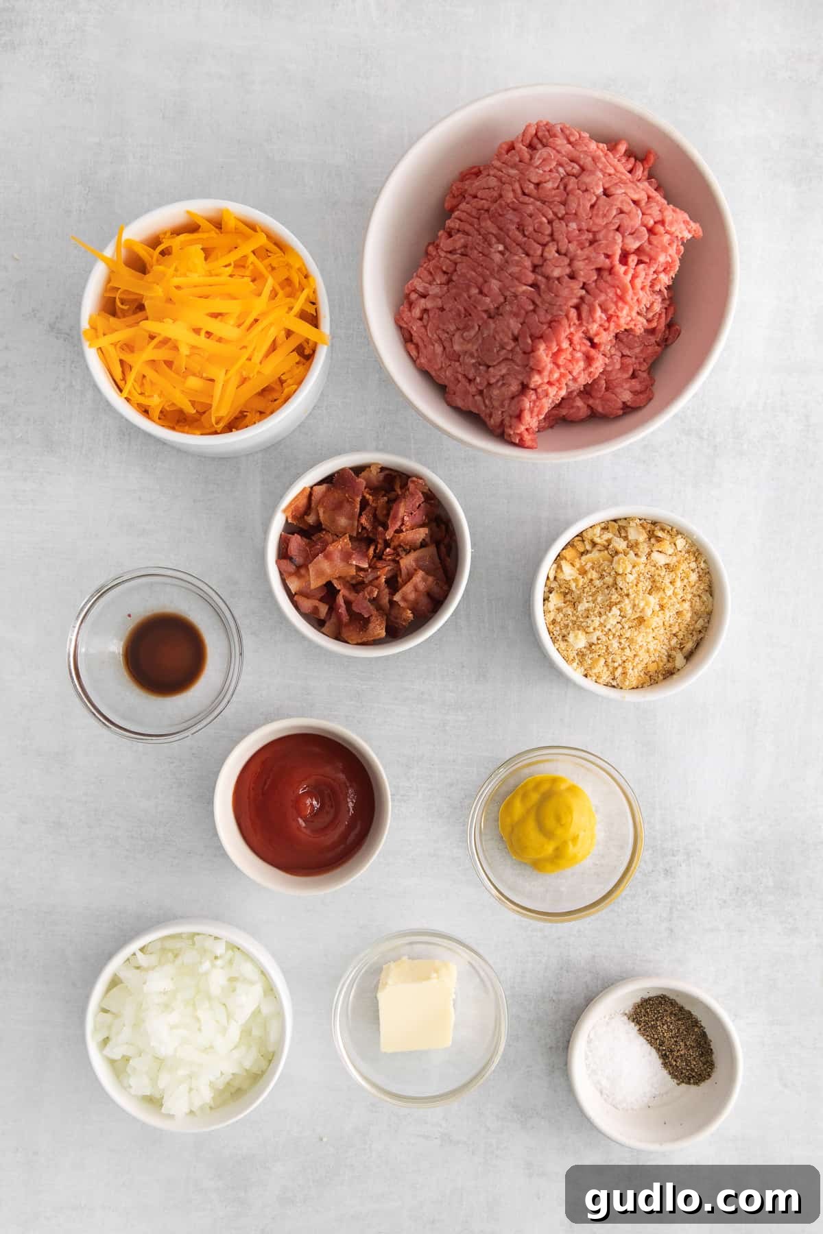 Key Ingredients for Perfect Cheeseburger Meatballs Assortment of fresh ingredients for making cheeseburger meatballs, neatly arranged in bowls.
