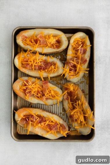 Golden Cheesy Potato Bites 12 Potato skins filled with melted cheddar cheese and crispy bacon, fresh from the oven, before adding sour cream.