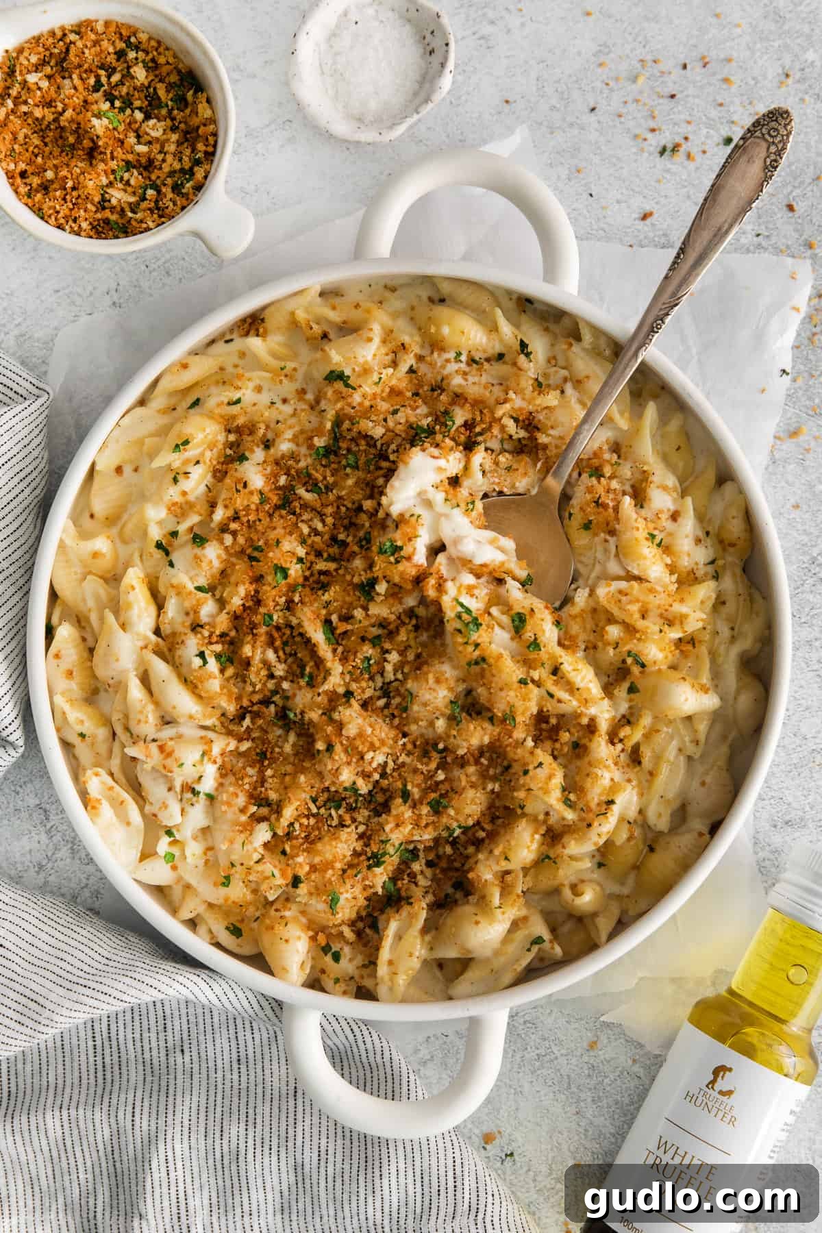 Decadent Truffle Mac 2 A serving of rich Truffle Mac and Cheese topped with crispy breadcrumbs, ready to be enjoyed.