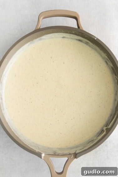 Preparing the roux for the cheese sauce in a pot.