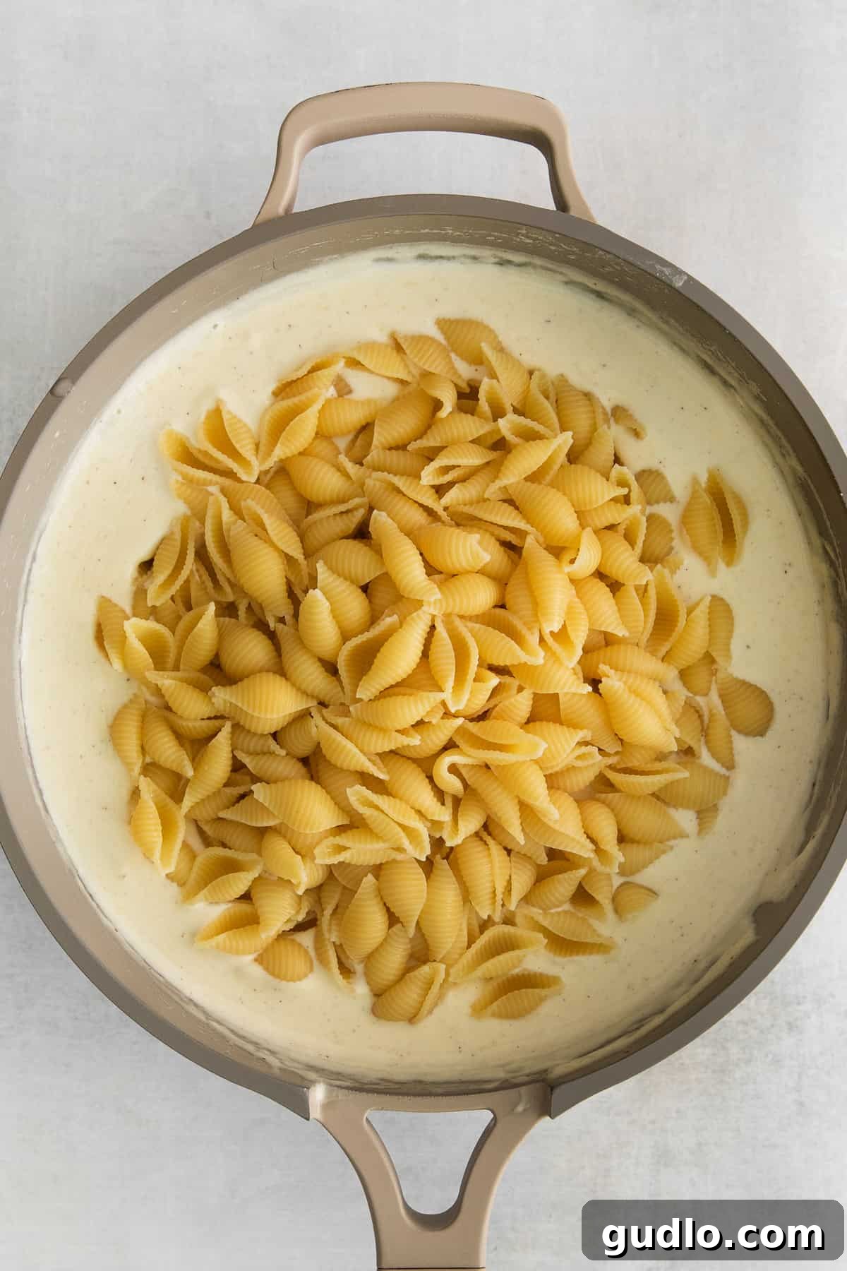 Decadent Truffle Mac 5 Creamy truffle mac and cheese featuring shell-shaped noodles, perfectly coated in a rich sauce.