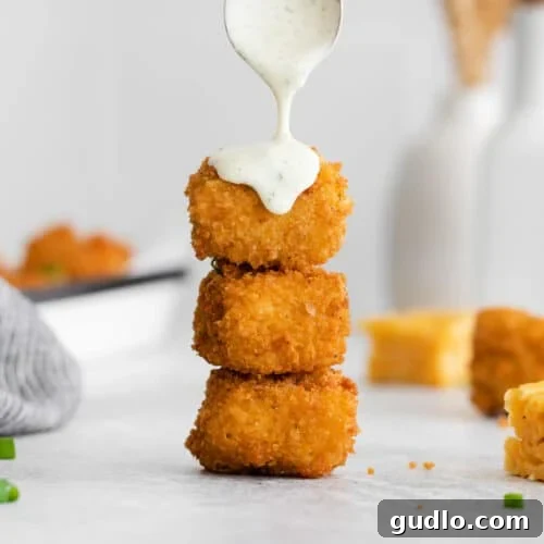 Drizzling golden-fried mac and cheese balls with creamy ranch dressing, ready to serve.