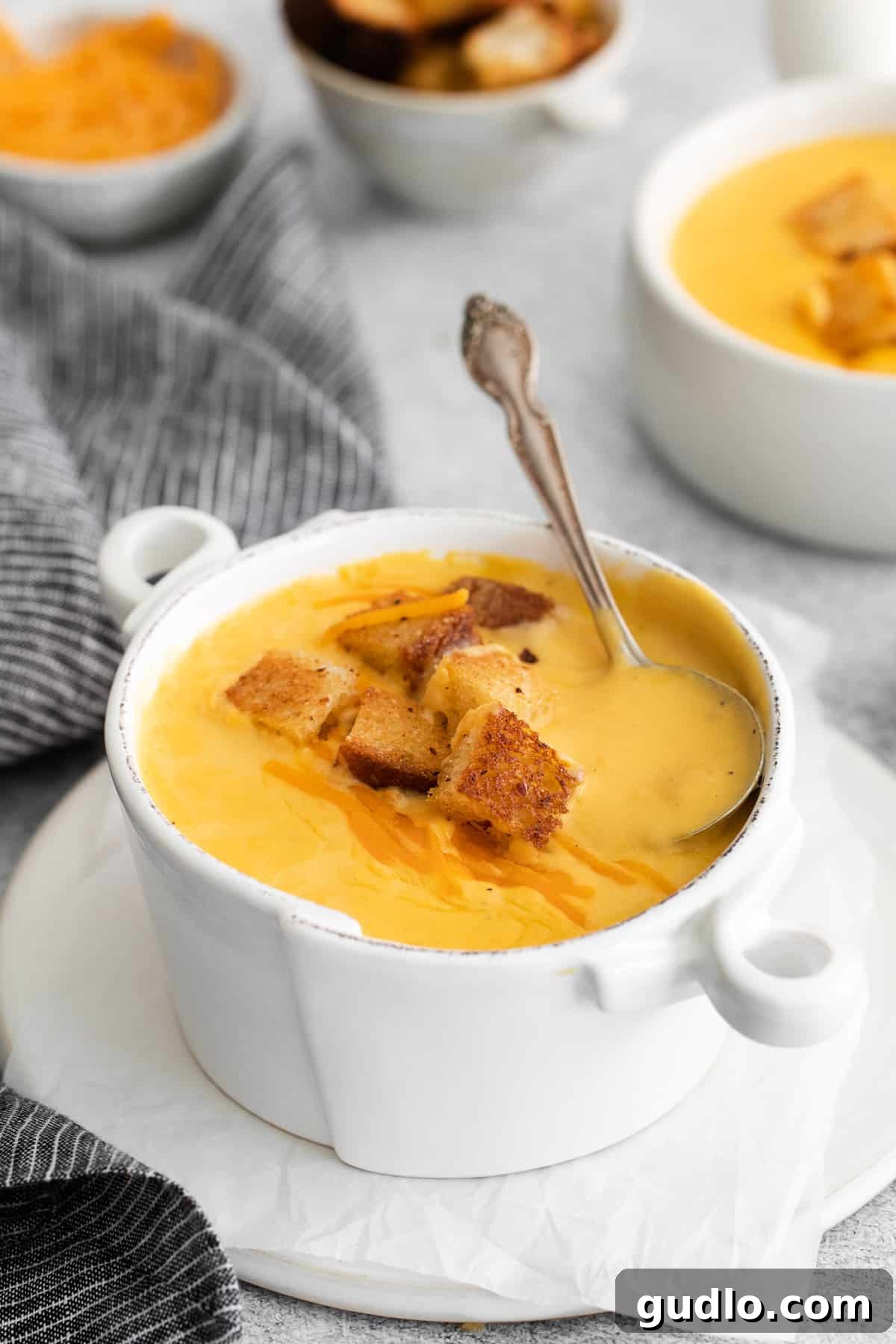 Creamy Cheddar Cheese Soup with Croutons A steaming bowl of creamy homemade cheddar cheese soup, garnished with crunchy croutons, ready to be enjoyed.