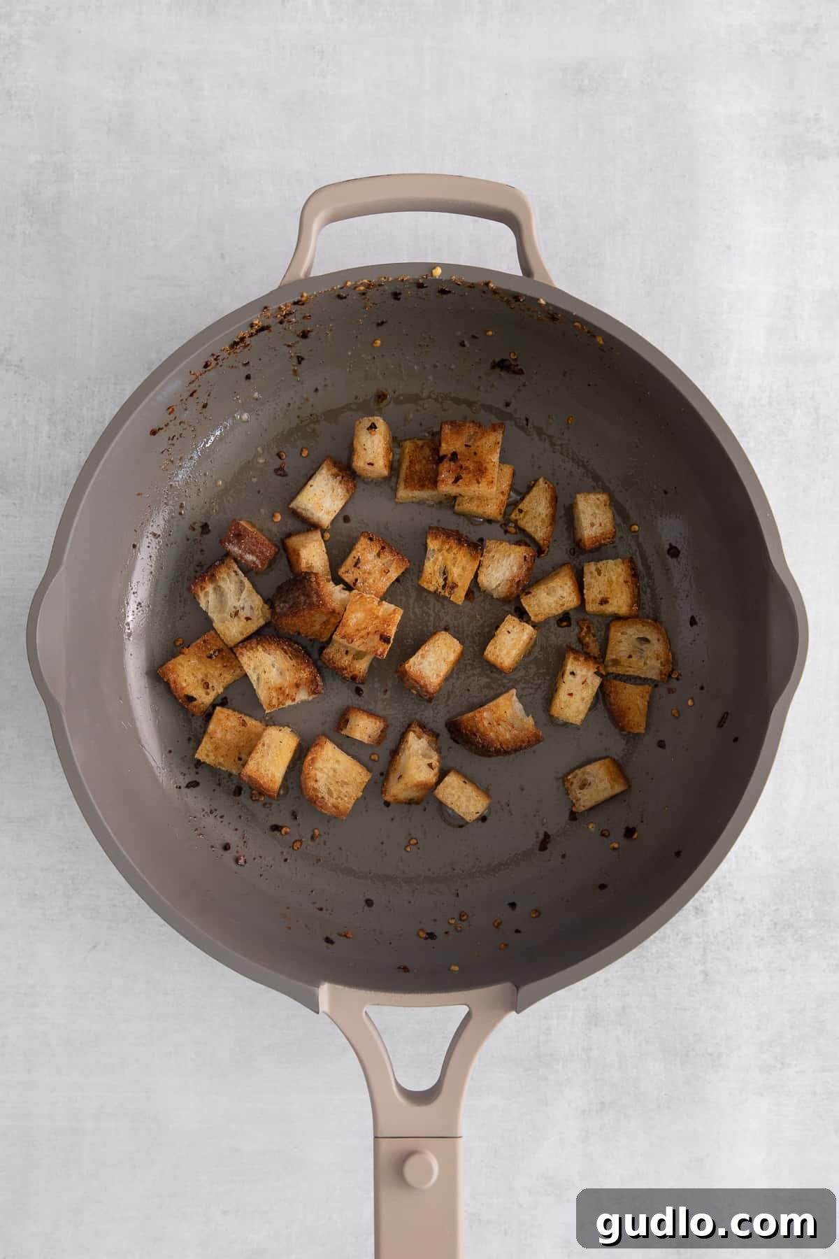 Quick Croutons in Skillet Golden brown, crispy quick croutons being tossed in a skillet, ready to top a delicious soup.