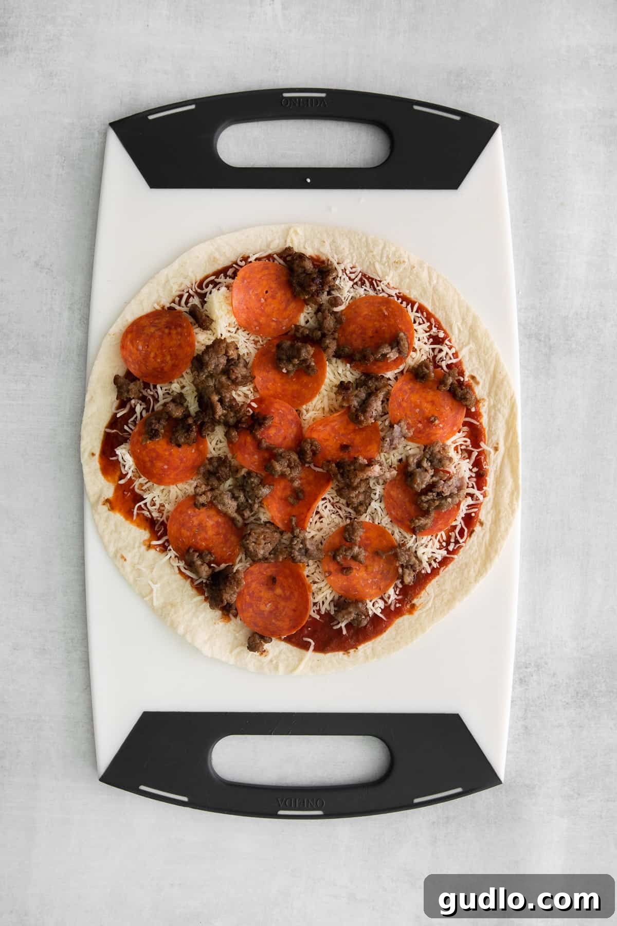 Pizza-Dilla Delight 4 A large flour tortilla layered with pizza sauce, shredded mozzarella cheese, cooked Italian sausage, and pepperoni.