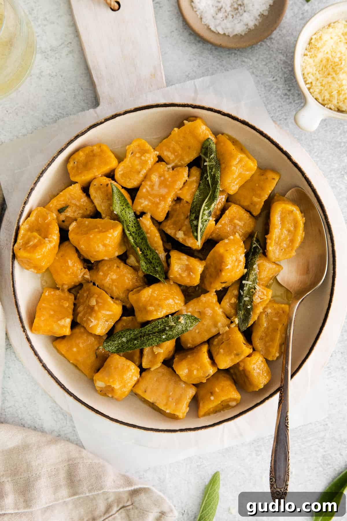 Pumpkin Gnocchi with Sage A beautiful bowl of homemade pumpkin gnocchi garnished with fresh sage leaves, ready to be served.