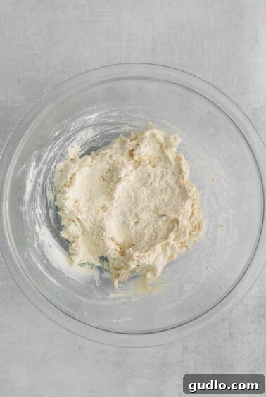 Crispy Creamy Crab Puffs 3 Cream cheese and crab mixture in a bowl, perfectly blended and ready for filling wontons.