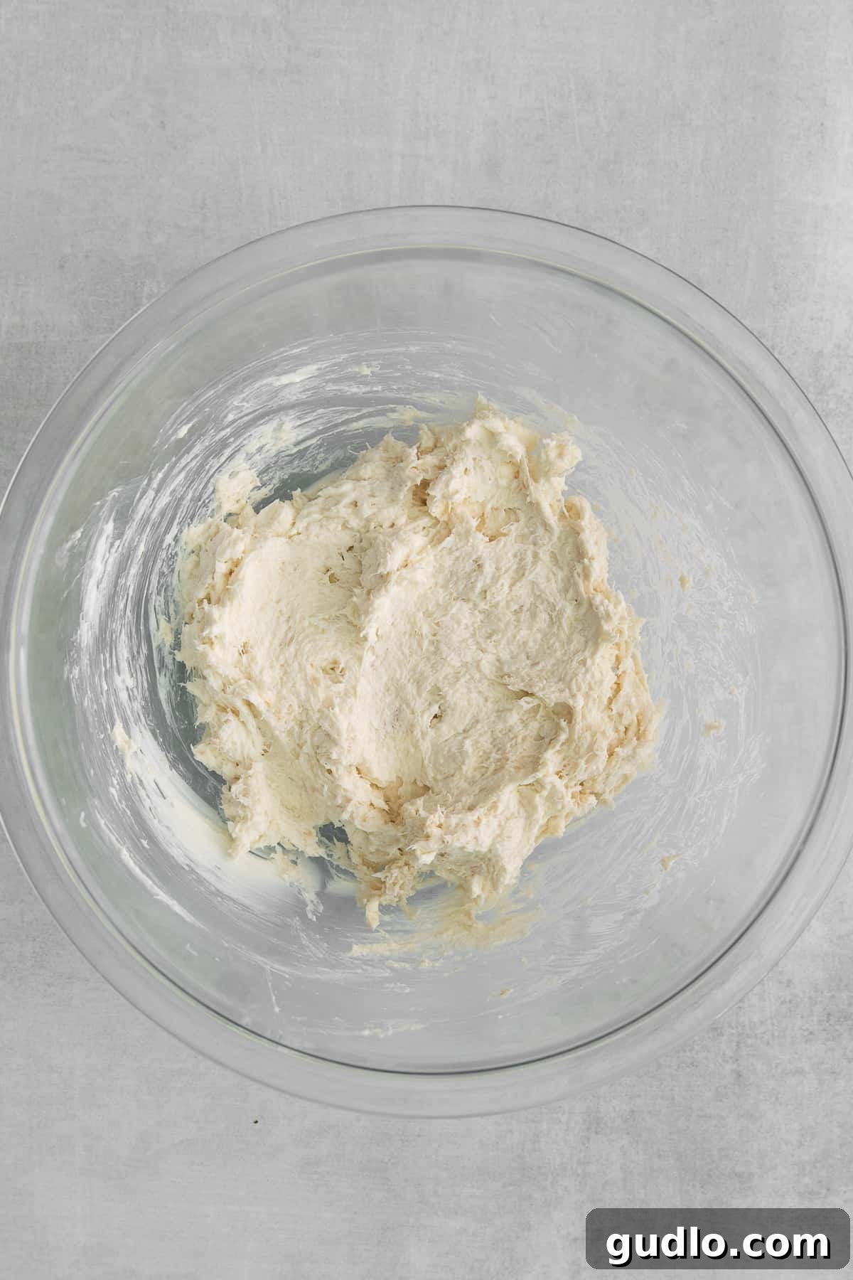 Creamy Crab Rangoon Filling Preparation Close-up of the rich and creamy crab rangoon filling in a pristine white mixing bowl, ready to be scooped into wrappers.