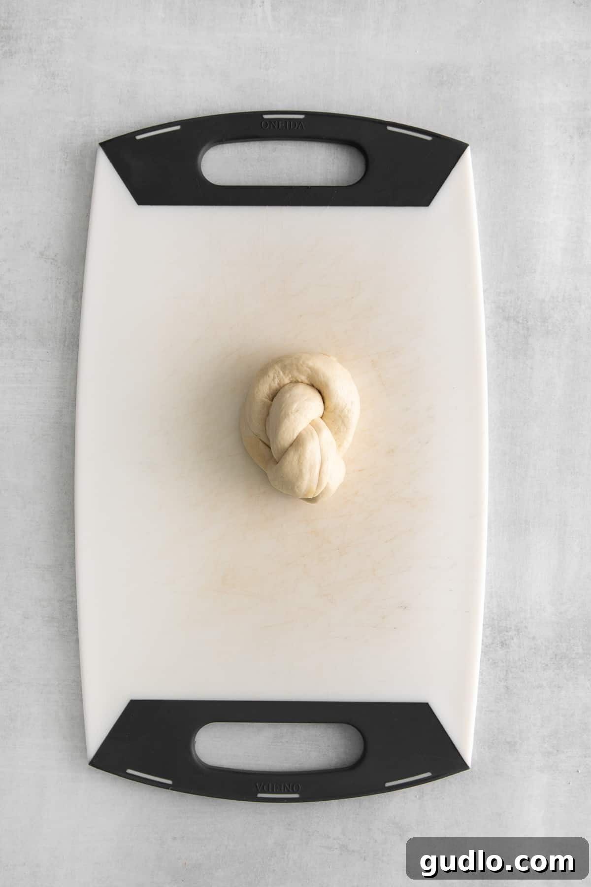 A baking sheet filled with perfectly formed dough knots, neatly arranged and ready for the oven.