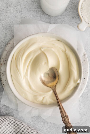 Thick whipped cream cheese frosting in a bowl, now at its final perfect consistency.