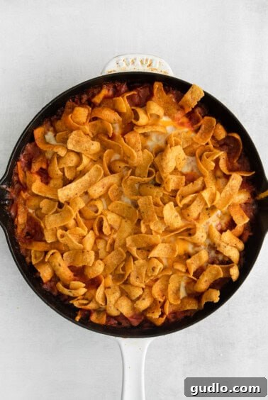 The Cheesy Frito Taco Skillet baking in the oven, with the Fritos and cheese melding together.
