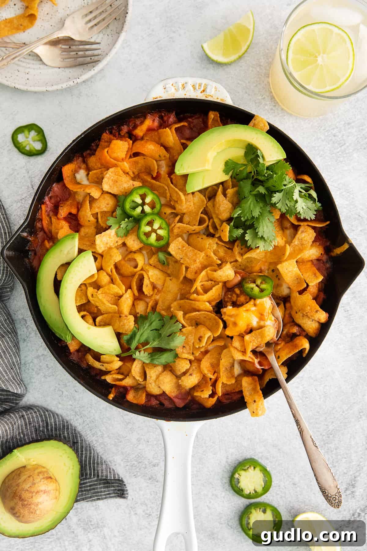 Close-Up of Cheesy Frito Taco Skillet on a Spoon A close-up shot of the Cheesy Frito Taco Skillet served on a spoon, highlighting the rich, cheesy, and crunchy texture of the dish.