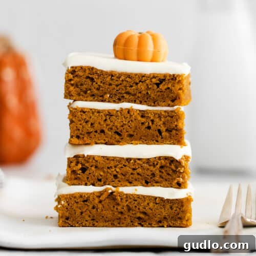 Beautifully frosted pumpkin bars ready for serving, highlighting their appeal as a fall dessert.