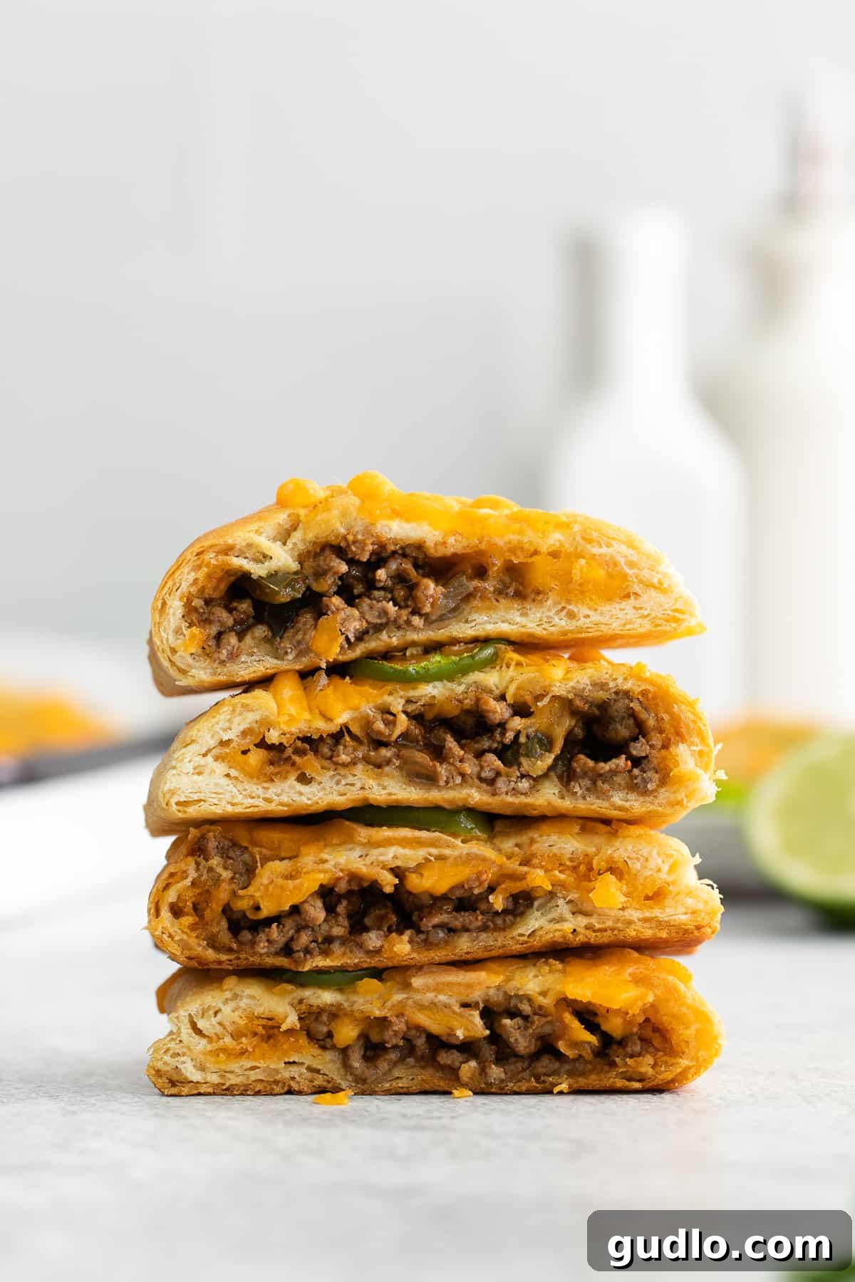 Effortless Taco Pockets 6 Stacked taco pockets, cut in half to reveal the savory beef and melted cheese filling.