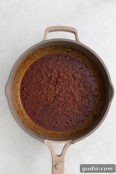 Cooked chorizo in a pan, ready for the next step of adding cheese.