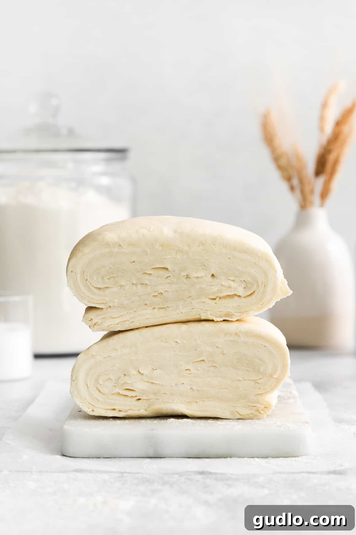 Freshly prepared homemade puff pastry dough on a cutting board, showcasing its smooth texture and readiness for baking into sweet or savory recipes.