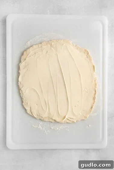 Softened butter spread on two-thirds of the dough.