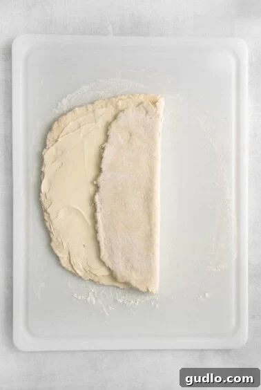 Puff pastry dough being folded into layers.