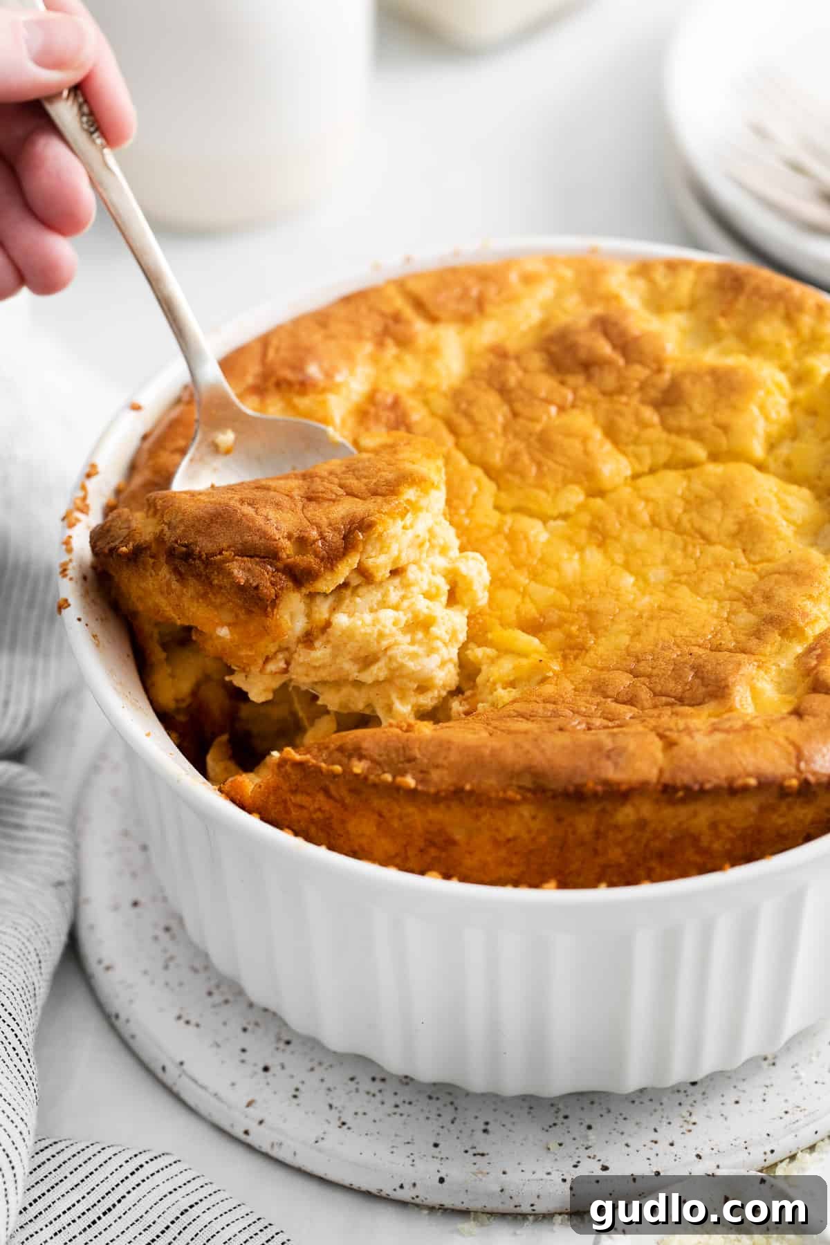 A close-up shot of a serving of cheese soufflé, showing its light and fluffy interior.