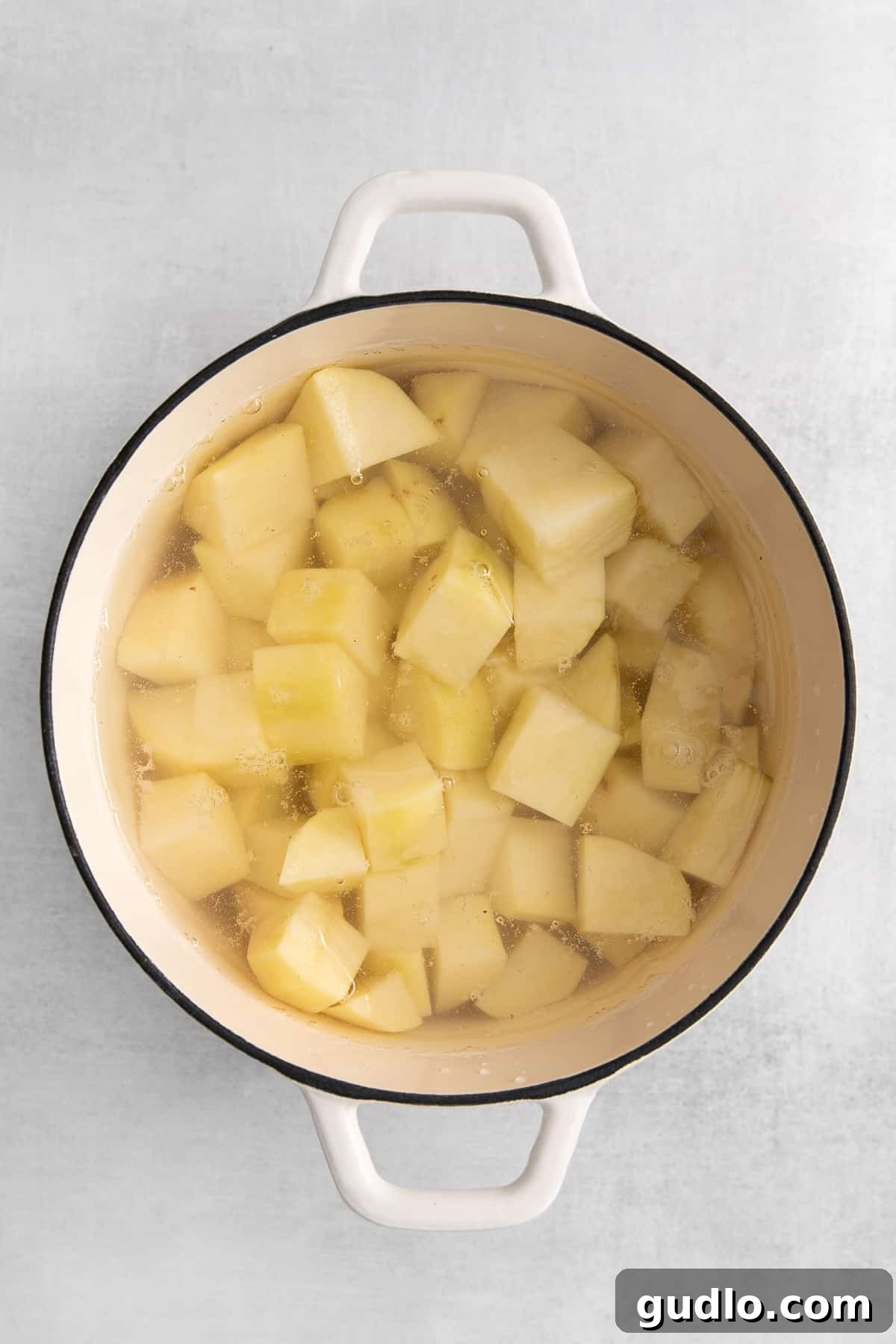 Velvet Smooth Cream Cheese Potatoes 3 Peeled and cubed russet potatoes ready for boiling.