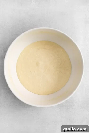 The creamy filling mixture for mini cheesecakes in a bowl.