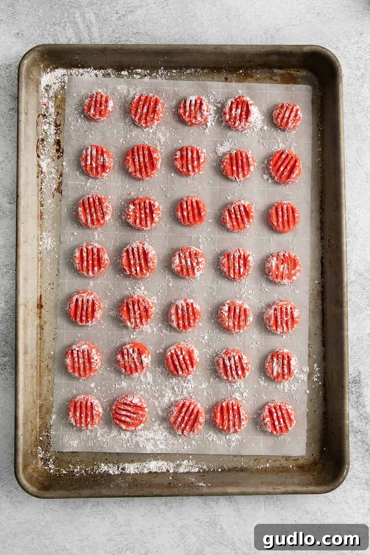 Homemade Cream Cheese Mints on a Baking Sheet Freshly shaped cream cheese mints lined up neatly on a parchment-lined baking sheet.
