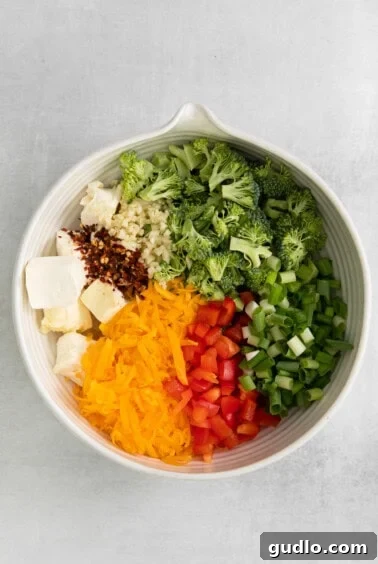 A white bowl filled with broccoli, cheese, and other ingredients, representing the stuffing mixture.