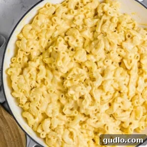 Classic macaroni and cheese in a skillet, showcasing its creamy texture.