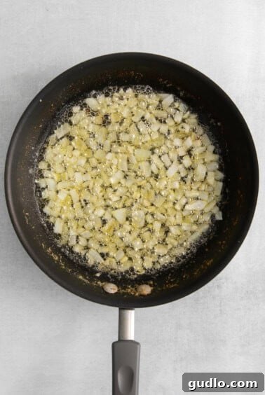 Fried onions in a frying pan on a white background.