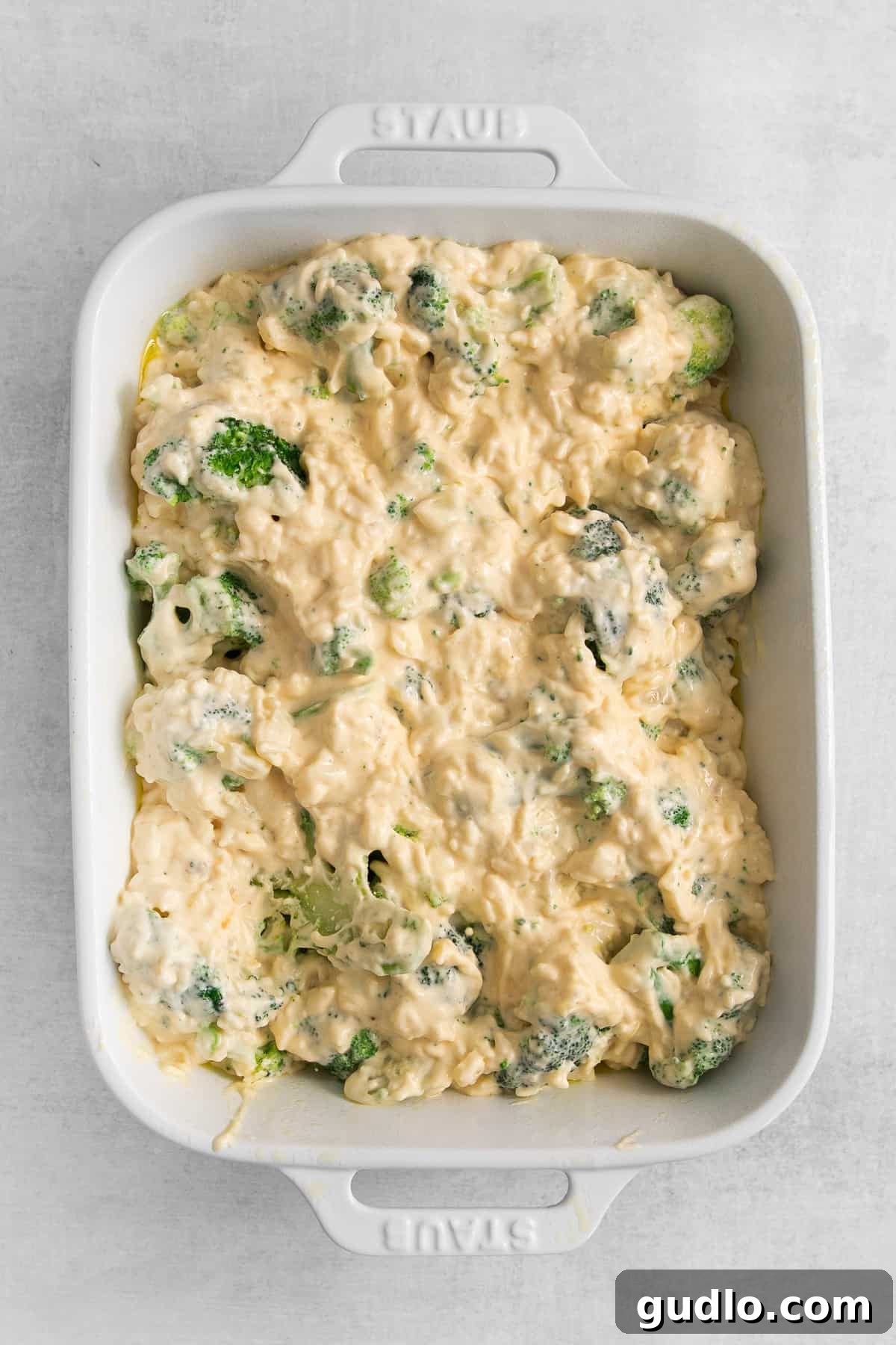 Baked broccoli cheese casserole in a ceramic casserole dish, ready to serve.