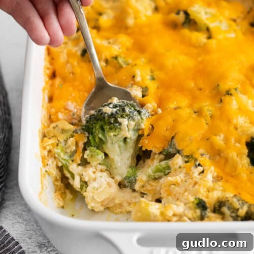 Broccoli cheese casserole in a square dish.