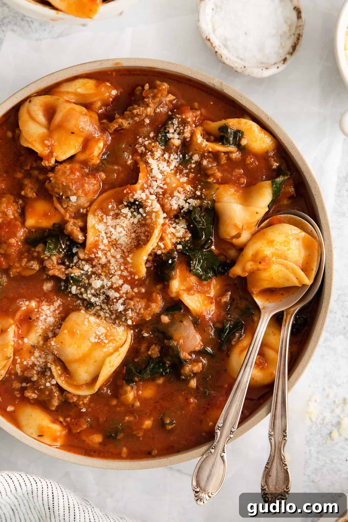 Hearty Cheese Tortellini Soup - The ultimate comfort food ready in 30 minutes. A steaming bowl of vibrant cheese tortellini soup, garnished with fresh herbs and parmesan.