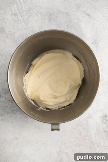 whipped cream in a metal mixing bowl.