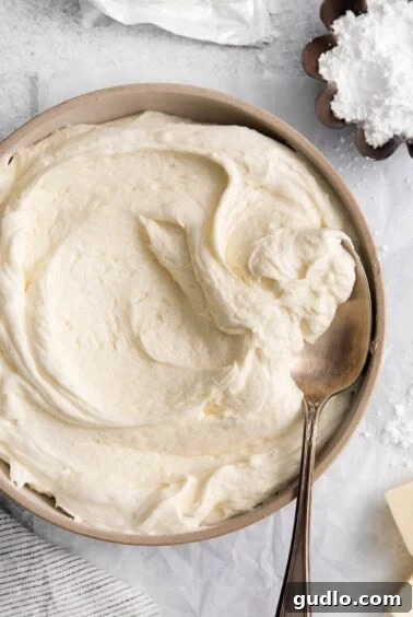 whipped cream in a bowl with a spoon.