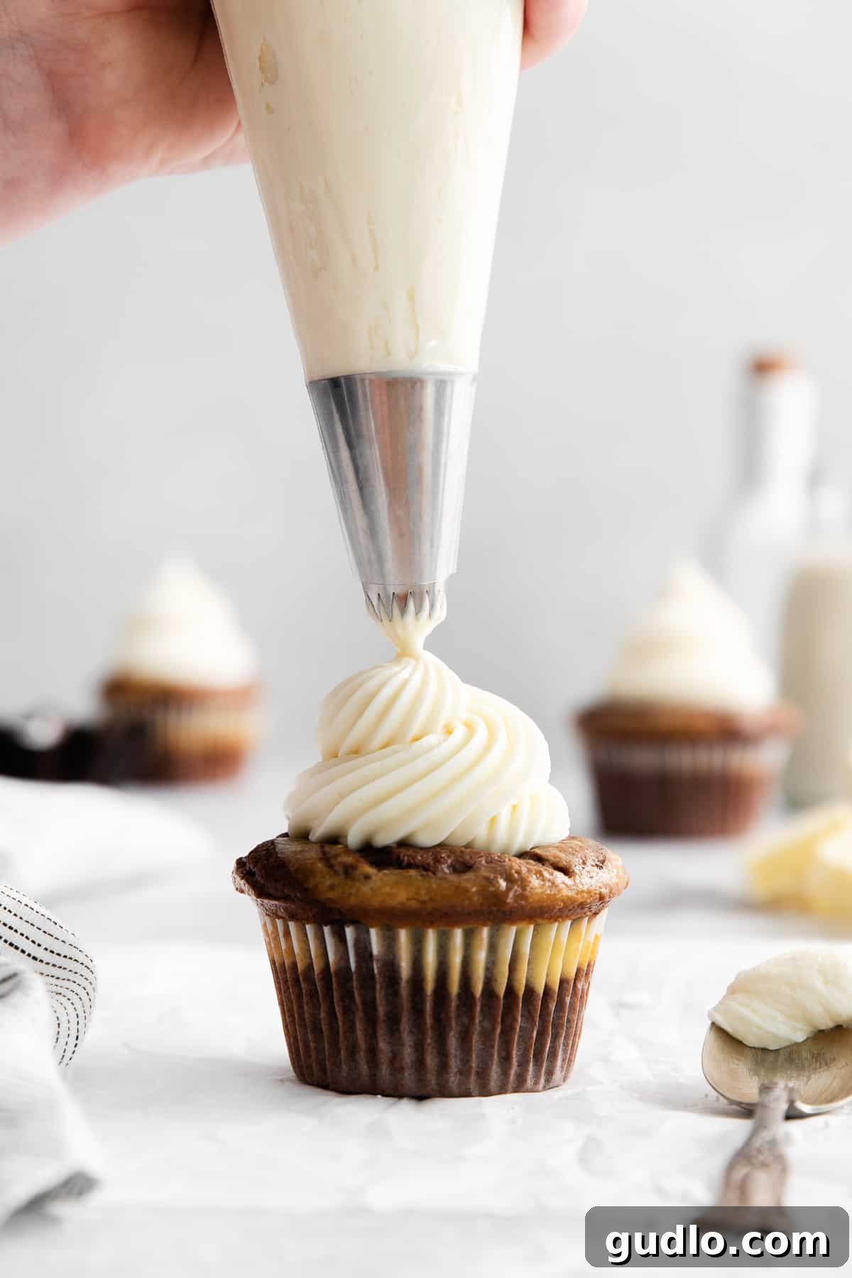 This cream cheese buttercream frosting is ultra-rich, creamy, and ridiculously easy to make! Cream cheese buttercream frosting on a cupcake.
