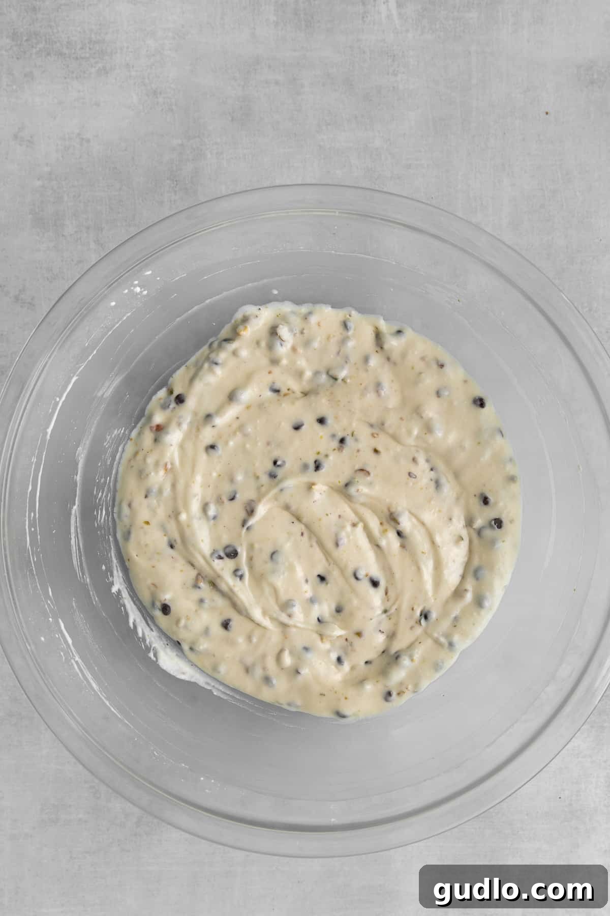 Cannoli Dream Dip 4 A serving bowl filled with velvety cannoli dip, adorned with chocolate chips and crushed pistachios, ready for dipping.