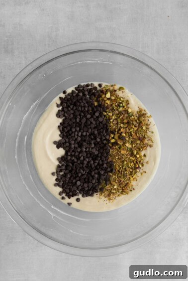 Finished cannoli dip with chocolate chips and pistachios on top, ready to serve.