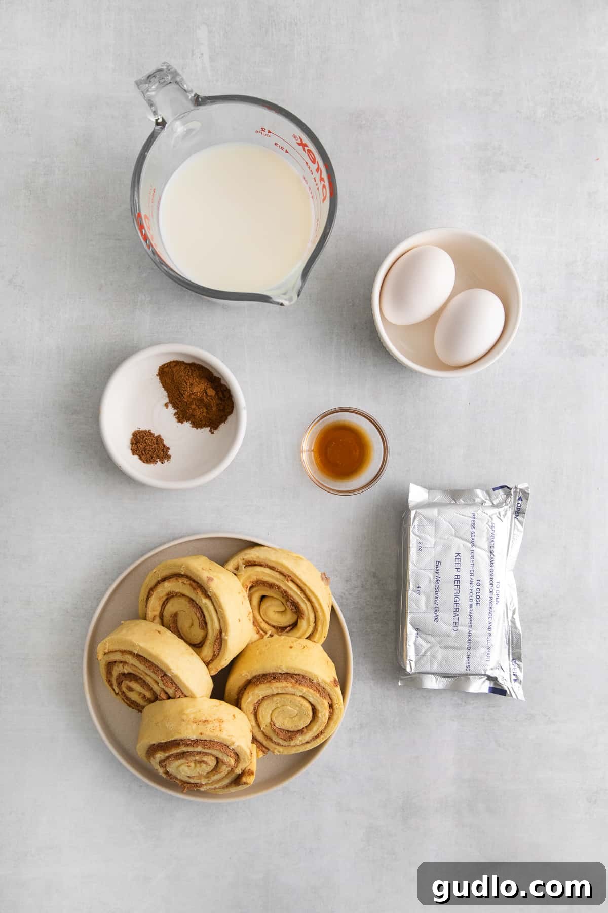 Essential ingredients for a delicious cinnamon roll casserole. Assorted ingredients laid out for making cinnamon roll casserole, including packaged cinnamon rolls, milk, eggs, and spices.