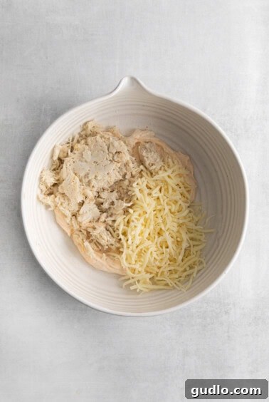A white bowl with creamy crab and cheese filling.