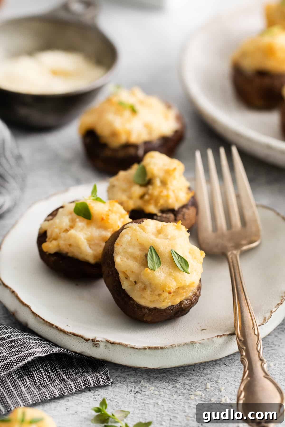 Cooked crab stuffed mushrooms arranged beautifully on a serving plate.